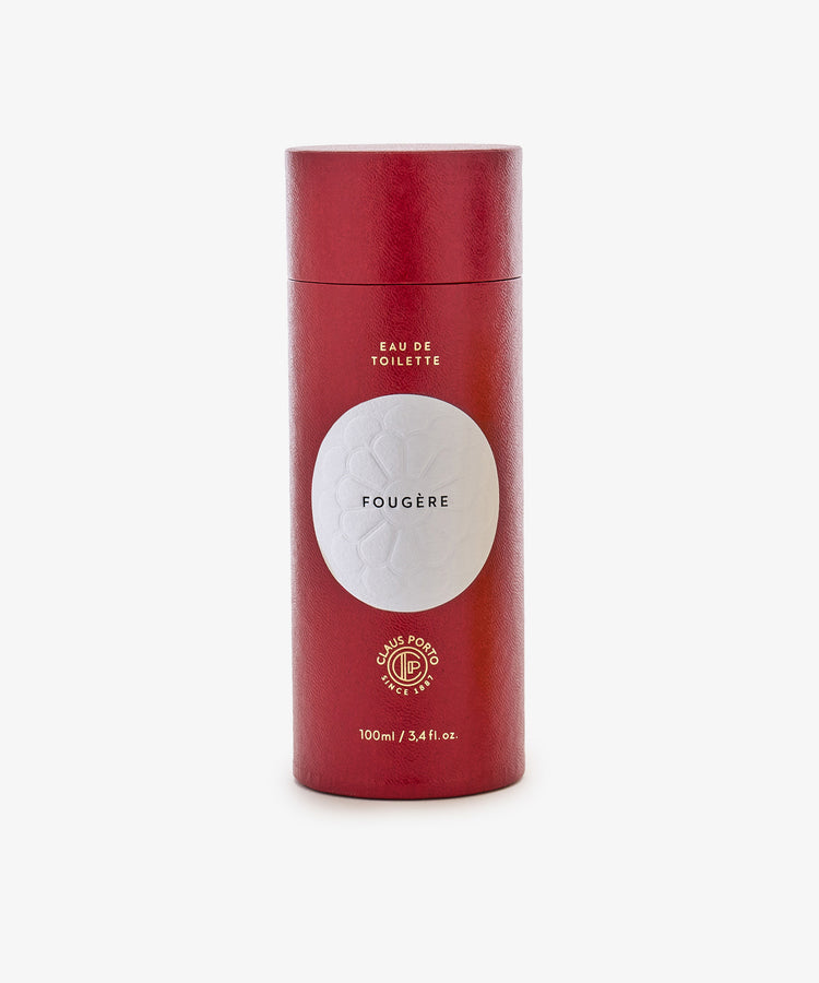 A red cylindrical container labeled Fougère Eau de Toilette, 100ml, stands upright on a plain white background.