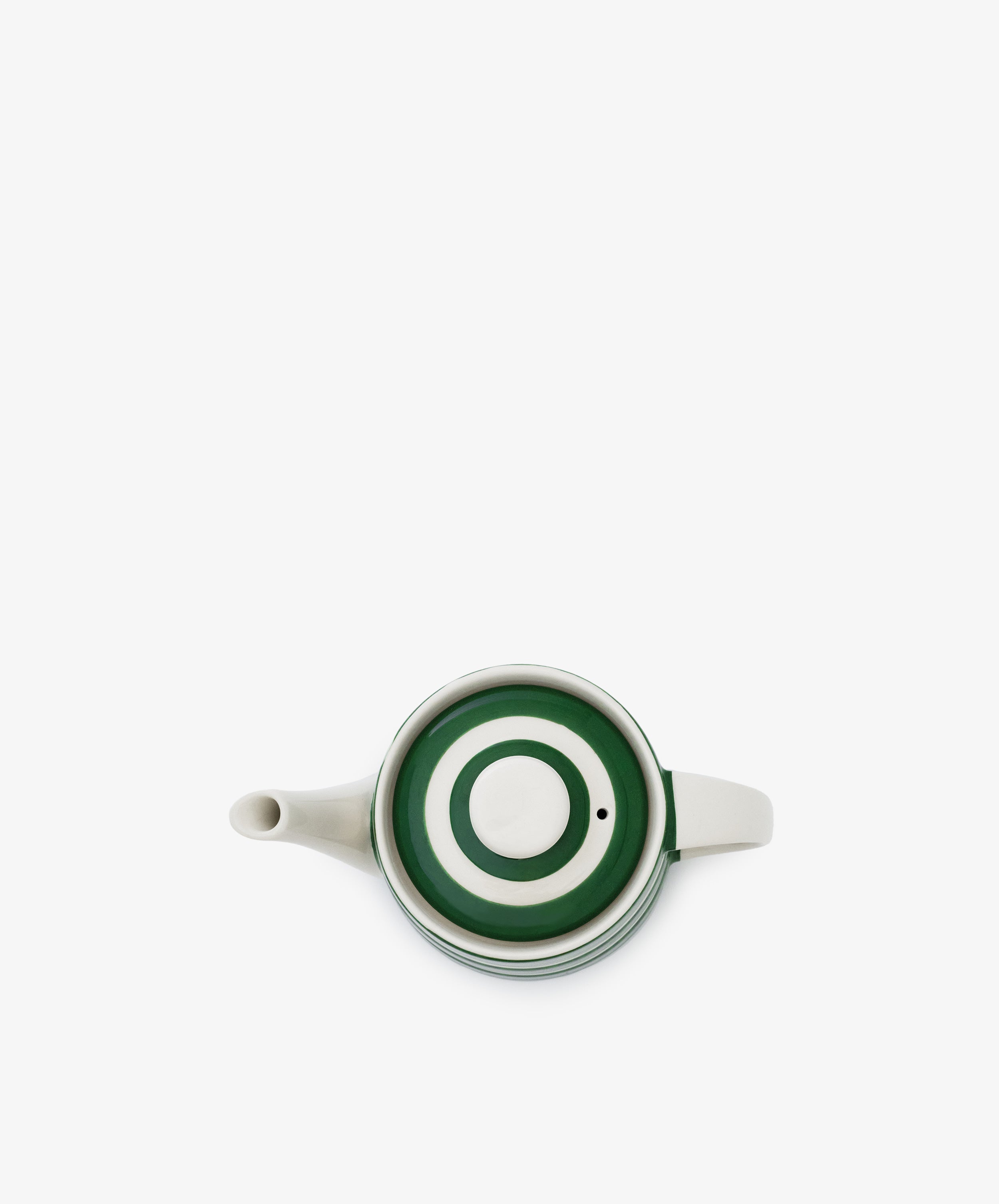 The Classic Teapot, a white kitchen essential, displays a green and white concentric circle pattern on its lid, seen from above against a plain white background.