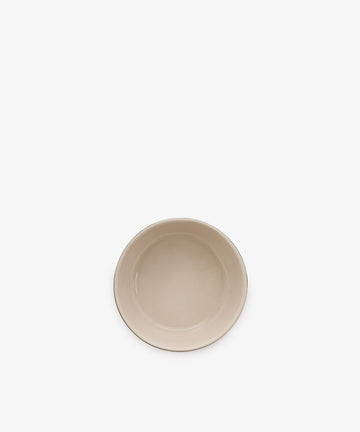 A single, empty, beige ceramic Betty Dip Dish is centered on a plain white background.