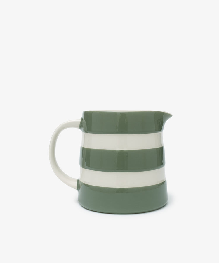 The Betty Large Dreadnought Jug is a ceramic piece with a handle, inspired by UK West Country pottery, and features green and white horizontal stripes on a plain white background.