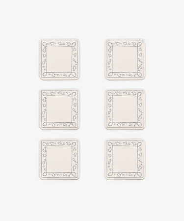 Six rectangular white Capriccio Coasters, set of 6, feature simple line-drawn borders with small heart shapes. Arranged in two columns and three rows on a white background, they echo a playful modern design.