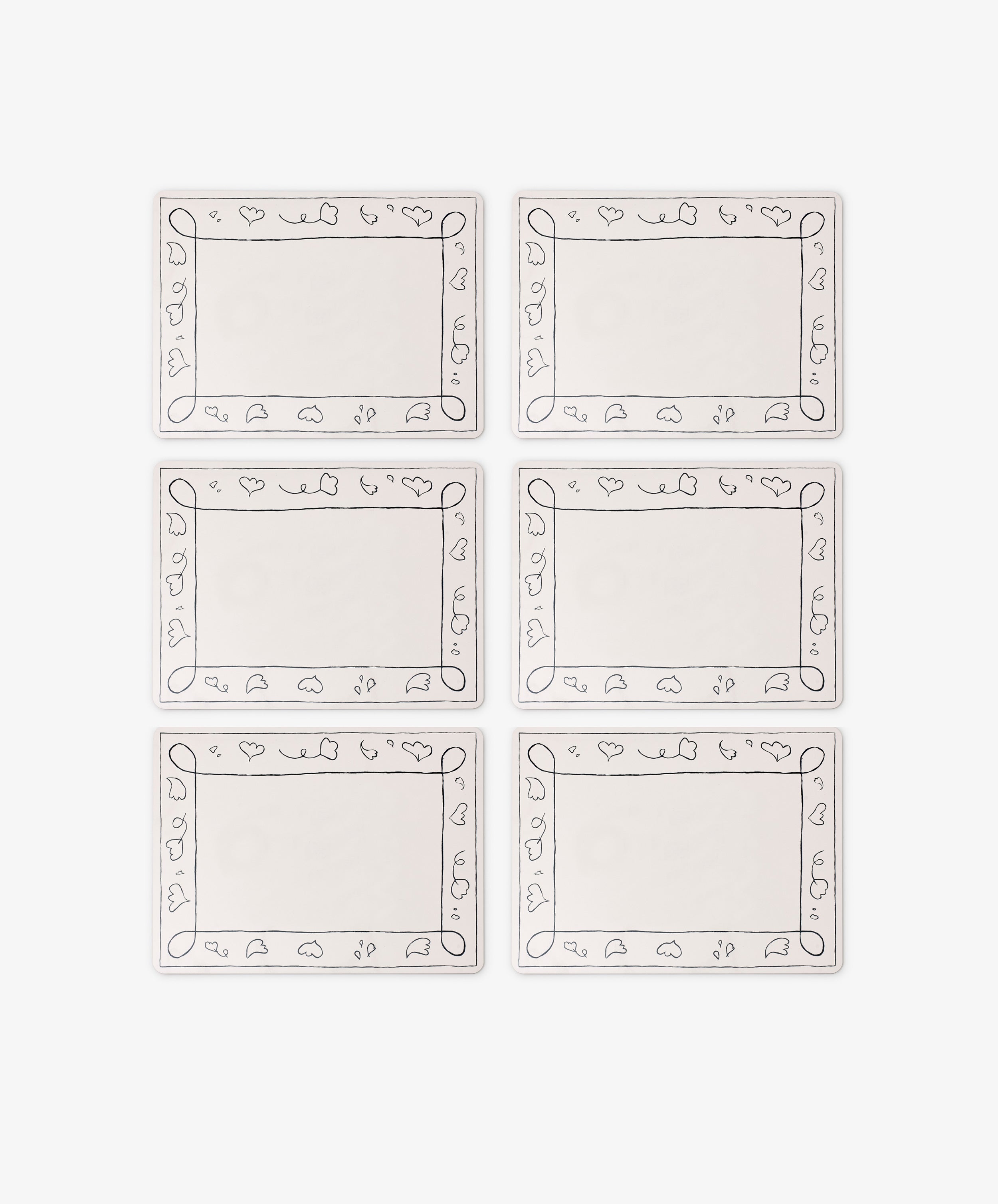 The Capriccio Placemat Set of 6 features rectangular white wipeable mats with simple fruit and leaf line borders, arranged in two rows of three—a stylish PORTA home accent.
