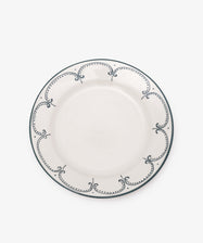 The Arco Dinner Plate, Set of 4 features white ceramic plates with a dark blue dotted and curved border, shown from above on a plain background—a beautiful example of contemporary tableware.
