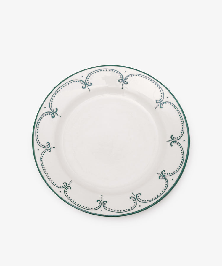 The Arco Dinner Plate, Set of 4 features white ceramic plates with a green dotted and curved border, shown on a plain white background—an elegant choice for contemporary tableware collections.