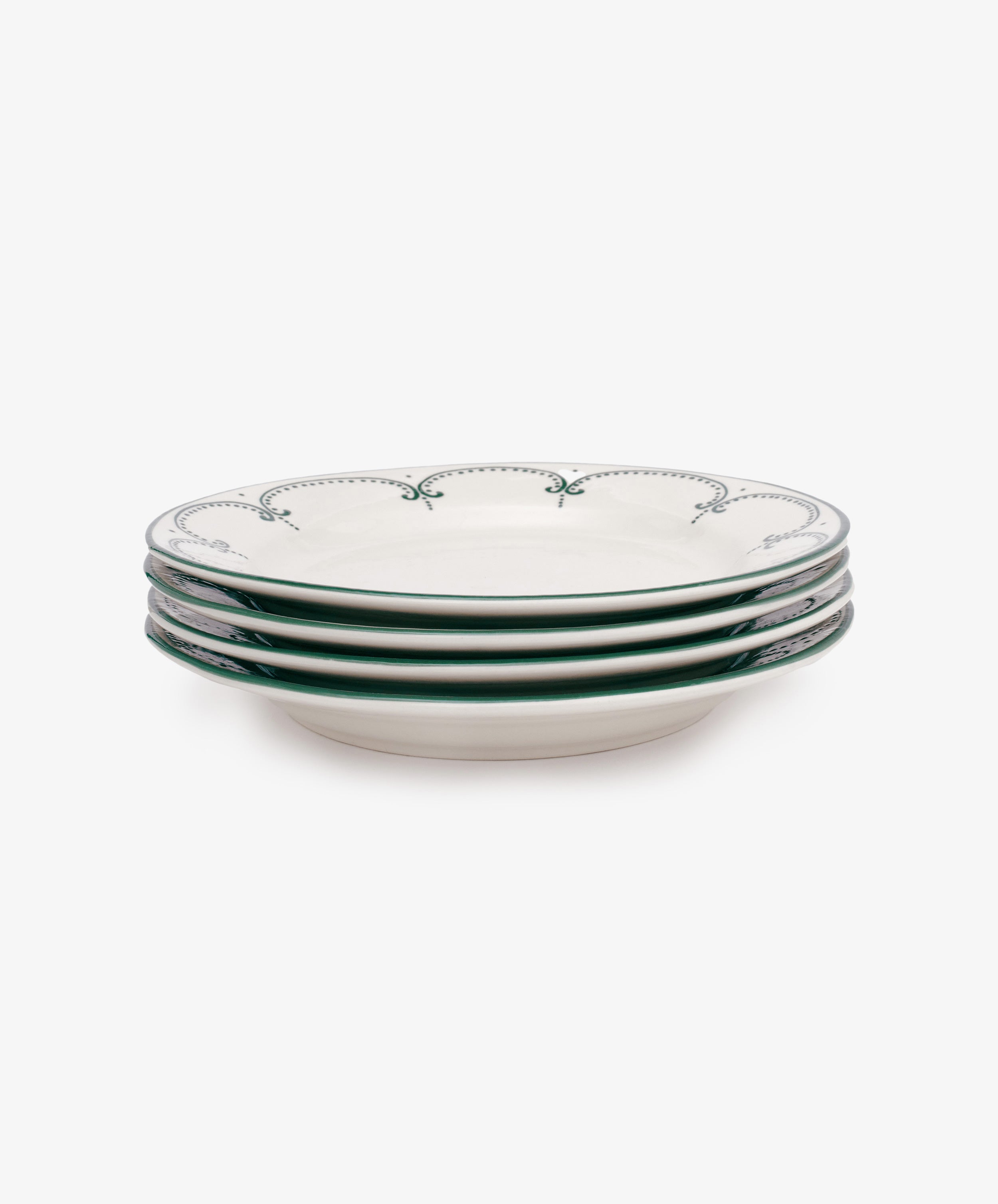 The Arco Dinner Plate, Set of 4, features white ceramic plates with green decorative rims, showcasing contemporary style and neatly arranged against a plain white background.