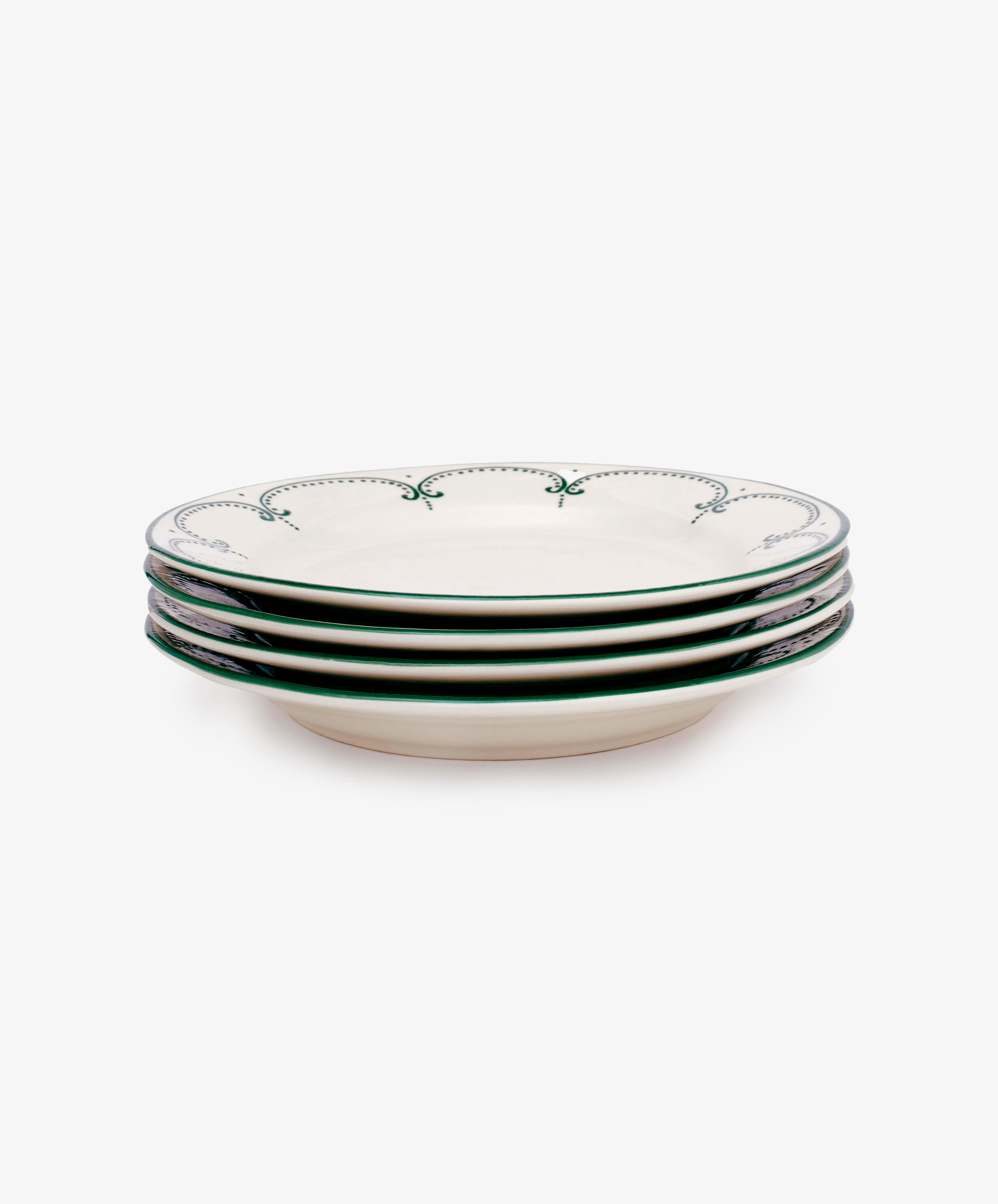 Set of four Arco Dinner Plates, each white with a green decorative rim in a traditional design, shown stacked on a plain white background.