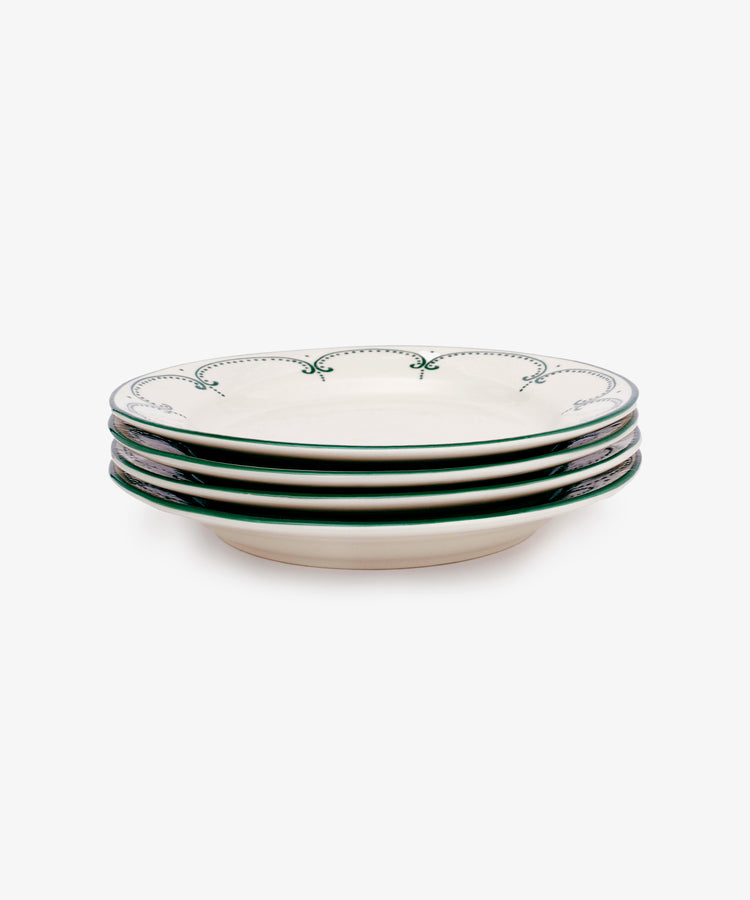 Set of four Arco Dinner Plates, each white with a green decorative rim in a traditional design, shown stacked on a plain white background.