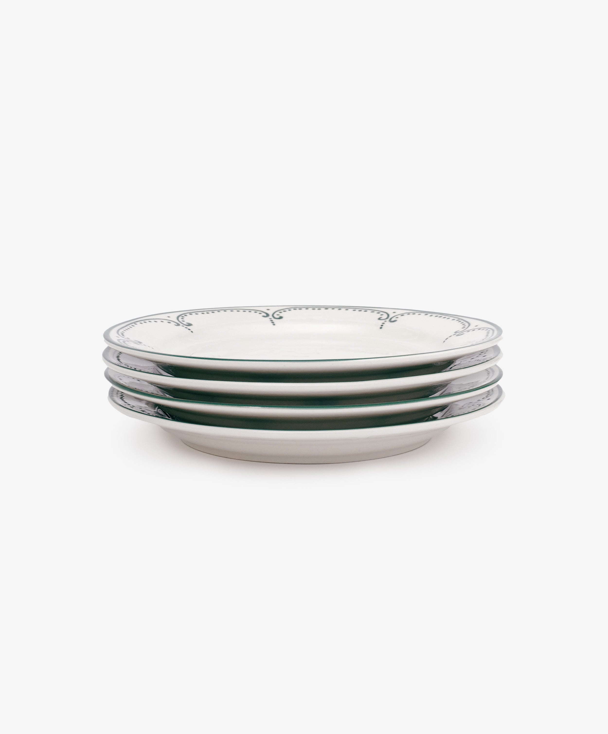 The Arco Small Plate, Set of 4, features white ceramic plates with traditional decorative edges, stacked side-on against a plain white background.