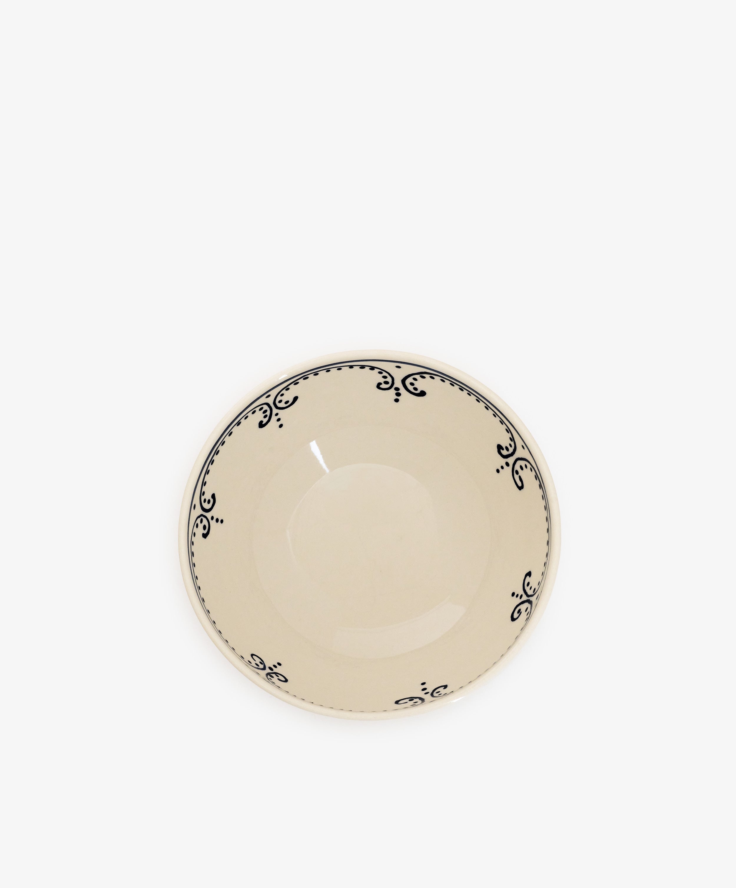 The Arco Cereal Bowl, Set of 4 features cream-colored ceramic bowls with shallow centers and decorative black rim patterns, shown against a white background for a modern tableware look.