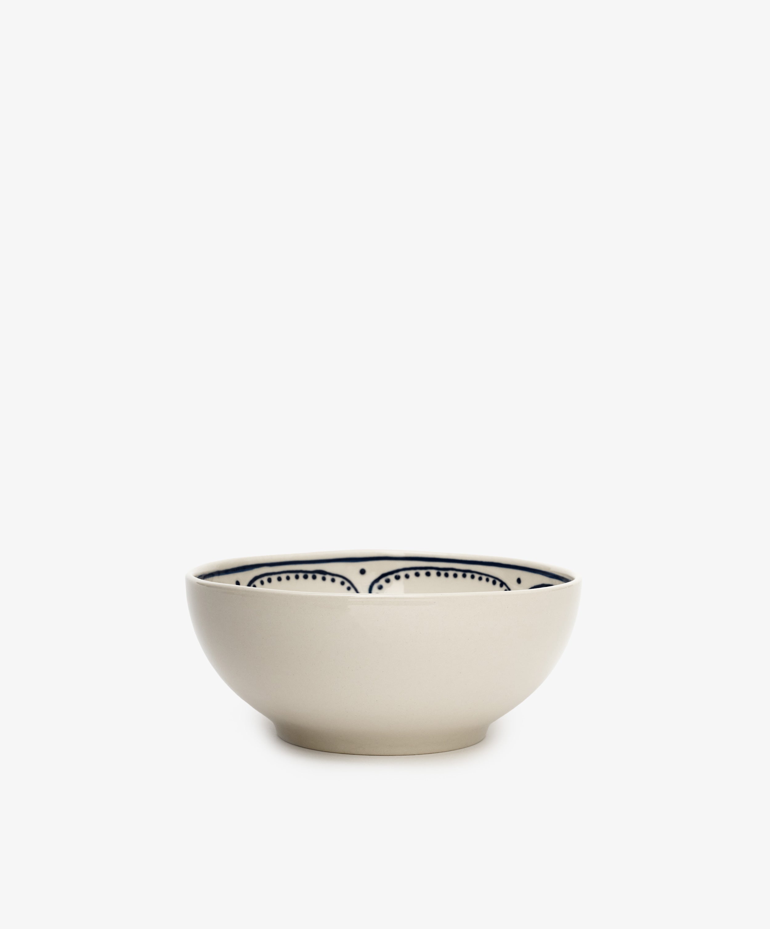 The Arco Cereal Bowl, Set of 4 features cream-colored handmade bowls with simple black dotted and curved line patterns inside—ideal for giving your tableware a contemporary touch.