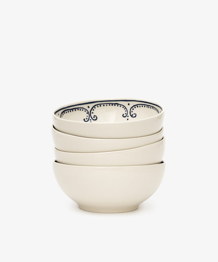 The Arco Cereal Bowl, Set of 4, features four white ceramic Portuguese bowls with a subtle blue inner rim design, ideal for anyone seeking contemporary yet charming tableware.