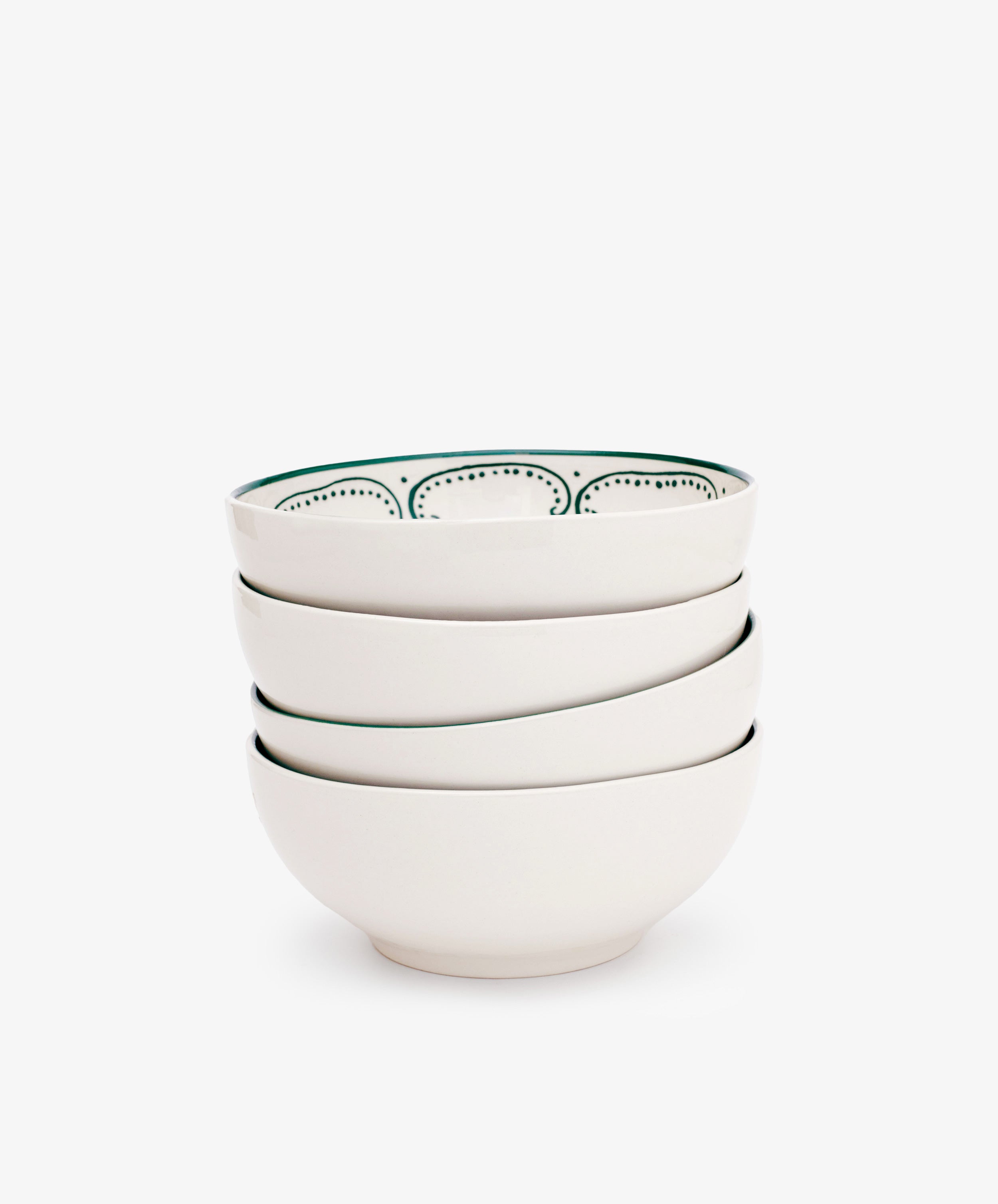 The Arco Cereal Bowl Set of 4 features white ceramic bowls, with the top bowl displaying a black dotted inner rim, combining a simple yet traditional design inspired by classic Portuguese bowls.