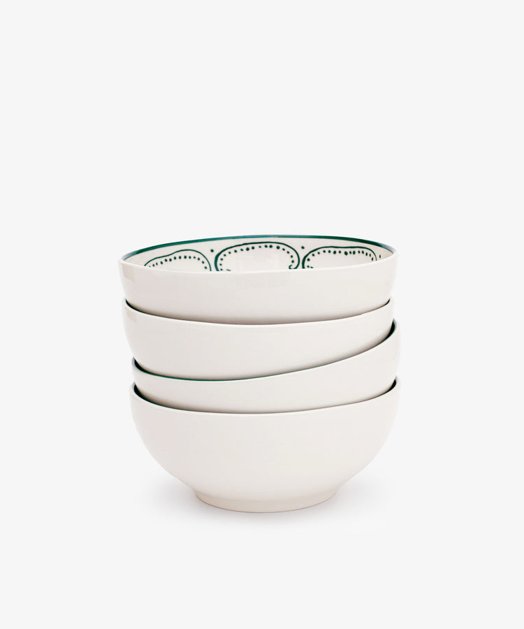 The Arco Cereal Bowl Set of 4 features white ceramic bowls, with the top bowl displaying a black dotted inner rim, combining a simple yet traditional design inspired by classic Portuguese bowls.