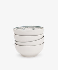 A set of four Arco Cereal Bowls is stacked, the top bowl highlighting a classic Portuguese black dotted rim design, all displayed on a plain white background.