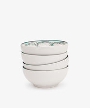 The Arco Cereal Bowl Set includes four white ceramic bowls, each with a simple dotted pattern on the inner rim—ideal for anyone who loves stylish, contemporary tableware.