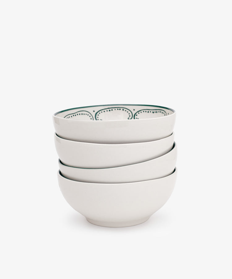 The Arco Cereal Bowl Set includes four white ceramic bowls, each with a simple dotted pattern on the inner rim—ideal for anyone who loves stylish, contemporary tableware.