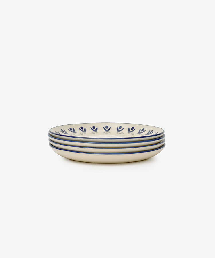 The Vito Small Plate, Set of 4, features cream-colored handmade ceramic plates with blue floral and stripe rims—an elegant dinnerware choice for everyday use.