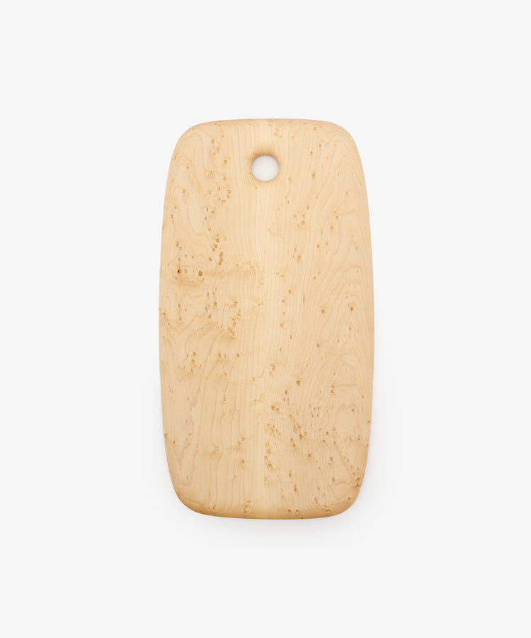 Birds Eye Maple Serving Board. Rounded edge tall, medium-sized rectangular wooden board with circular hole at top centre.