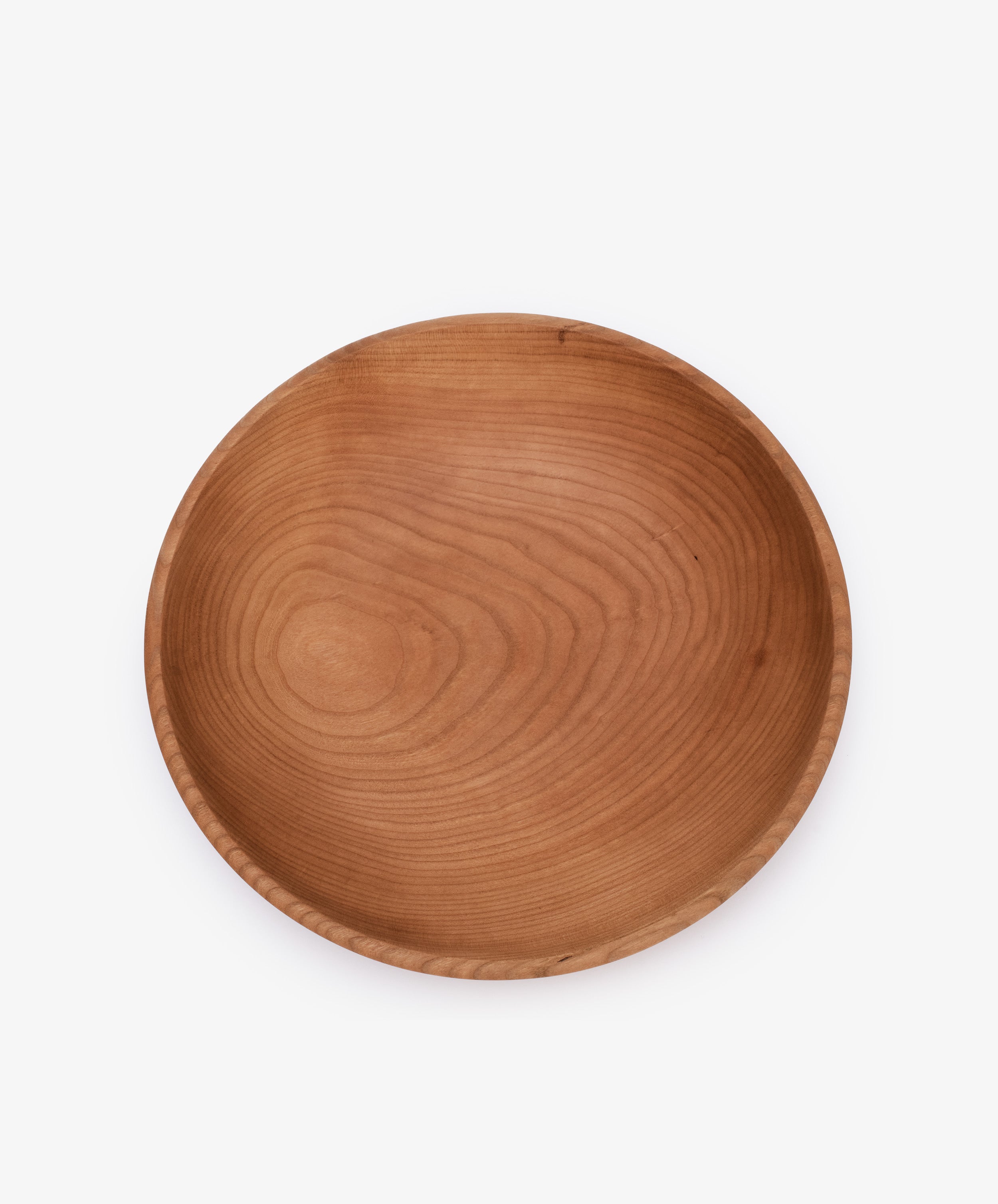 The August Wood Serving Bowl, a round and shallow handmade piece crafted from American dark cherry wood with a smooth finish, is shown from above on a plain white background.