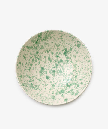 The Rita Bowl Splatter is a round ceramic bowl with a white base and green splatter design, shown from above against a plain background.