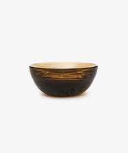 The Gem Dish is a round, translucent amber glass bowl with a smooth surface, shown against a plain white background.