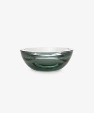 The Gem Dish is a round, transparent glass bowl with a subtle gray tint, shown against a plain white background.