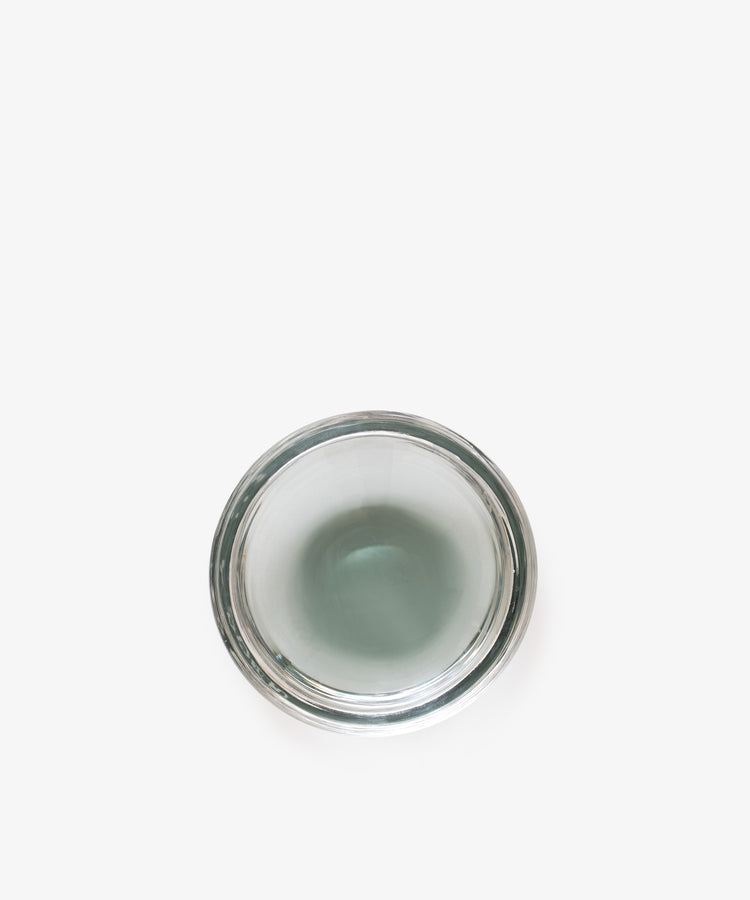 A top-down view of the Gem Dish, a clear glass container with a small amount of water, set against a white background.