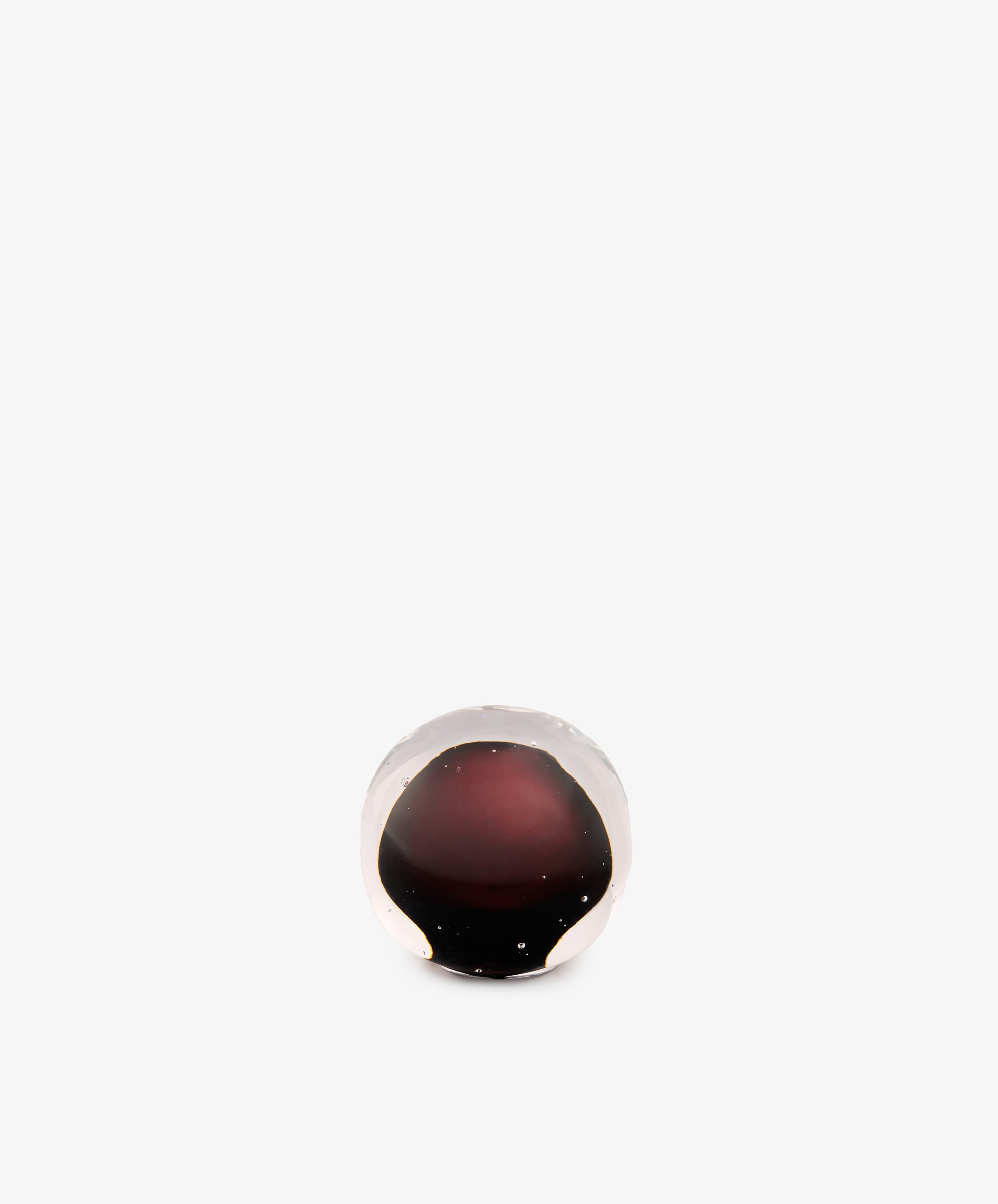 Pallino Paperweight: a hand-blown, spherical glass paperweight with a deep black cherry red core.