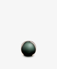 A Pallino Paperweight, hand-blown from glass in a spherical shape with a dark green core.