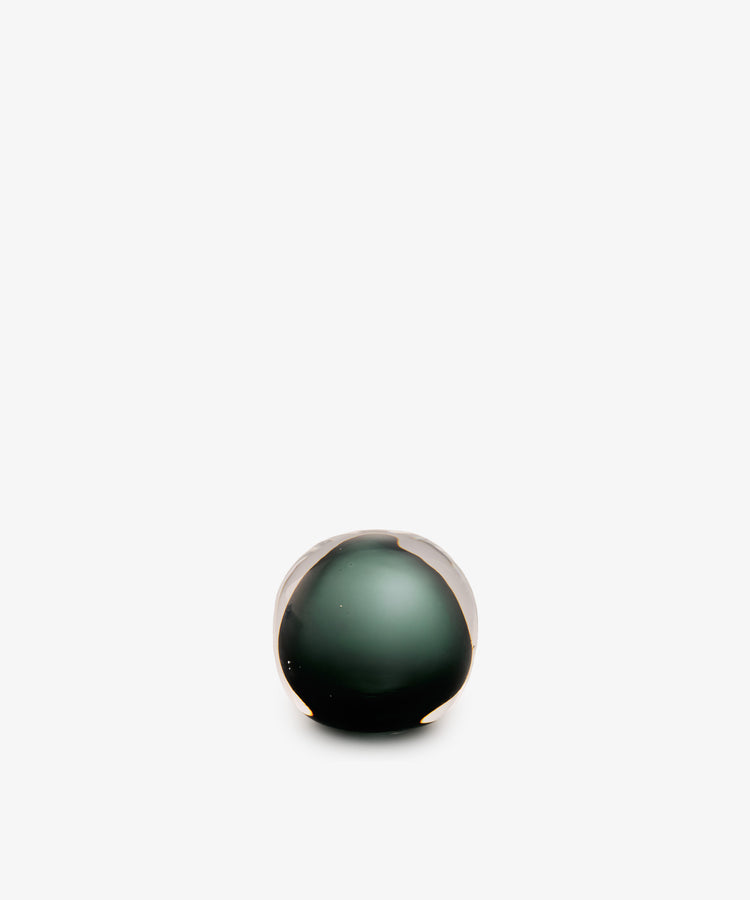 A Pallino Paperweight, hand-blown from glass in a spherical shape with a dark green core.