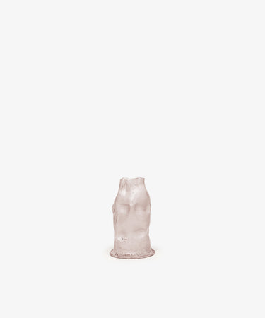 The Pellizco Candleholder, a small translucent pinkish sculptural form resembling a headless human torso, is centered against a plain white background.