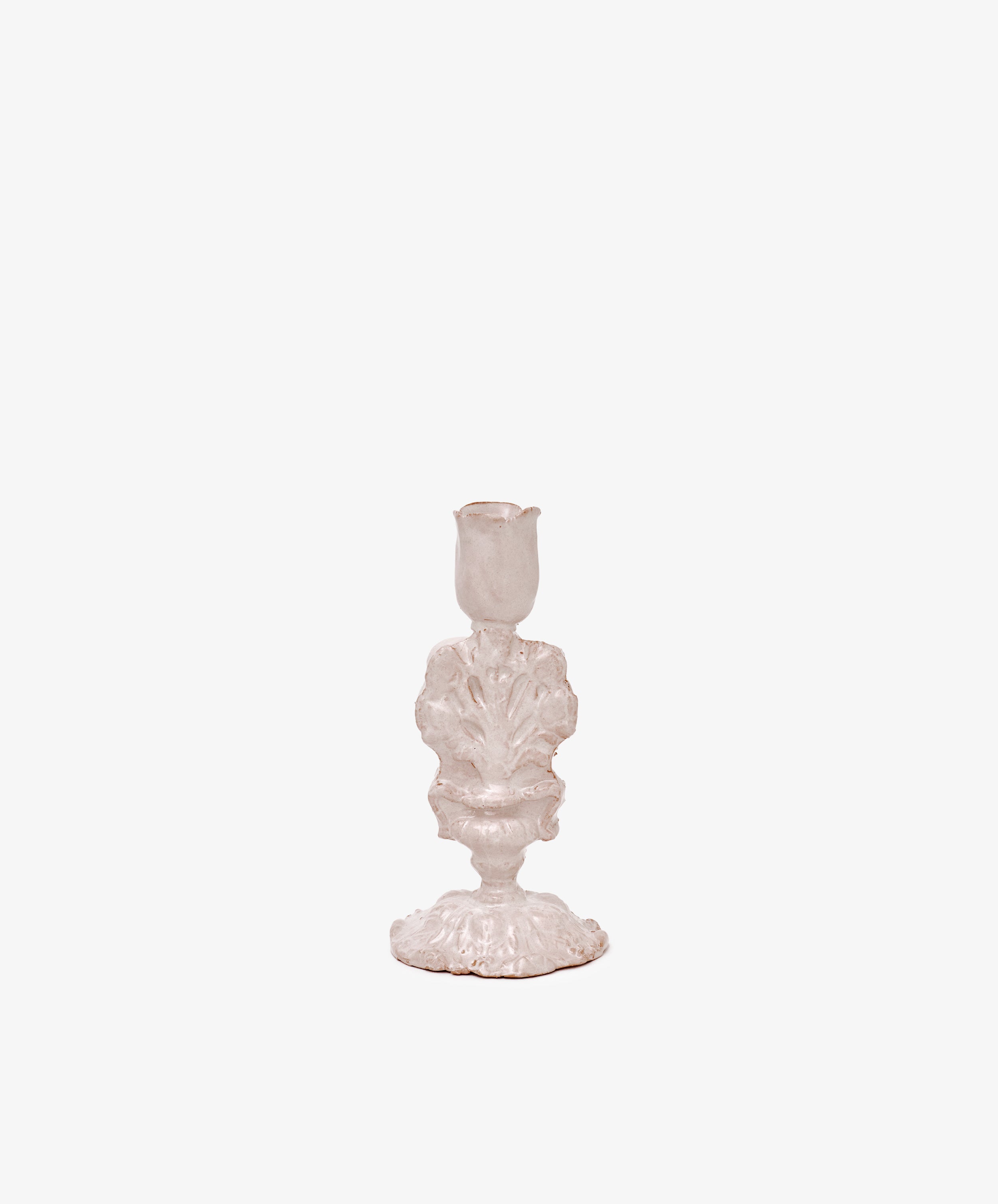 The Jarra De Flores Candleholder features an ornate, vintage-inspired white design with sculptural details, reminiscent of hand-moulded glazed pieces, shown against a plain white background.