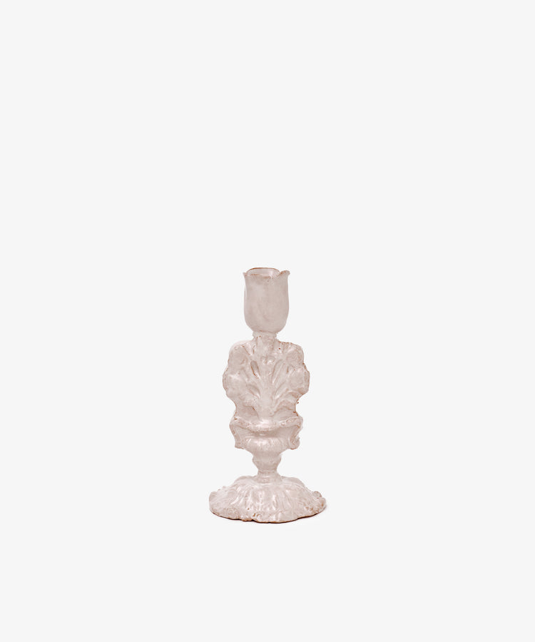 The Jarra De Flores Candleholder features an ornate, vintage-inspired white design with sculptural details, reminiscent of hand-moulded glazed pieces, shown against a plain white background.