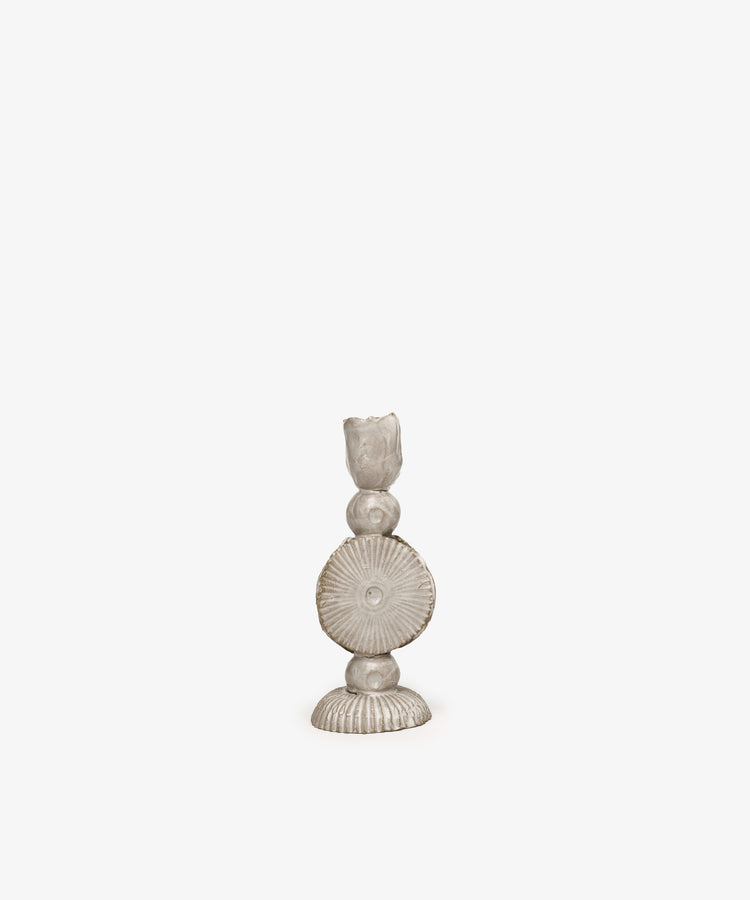 The Circulo Candleholder is a hand-moulded ceramic piece featuring a circular, ridged design and sculptural form, shown against a plain white background.