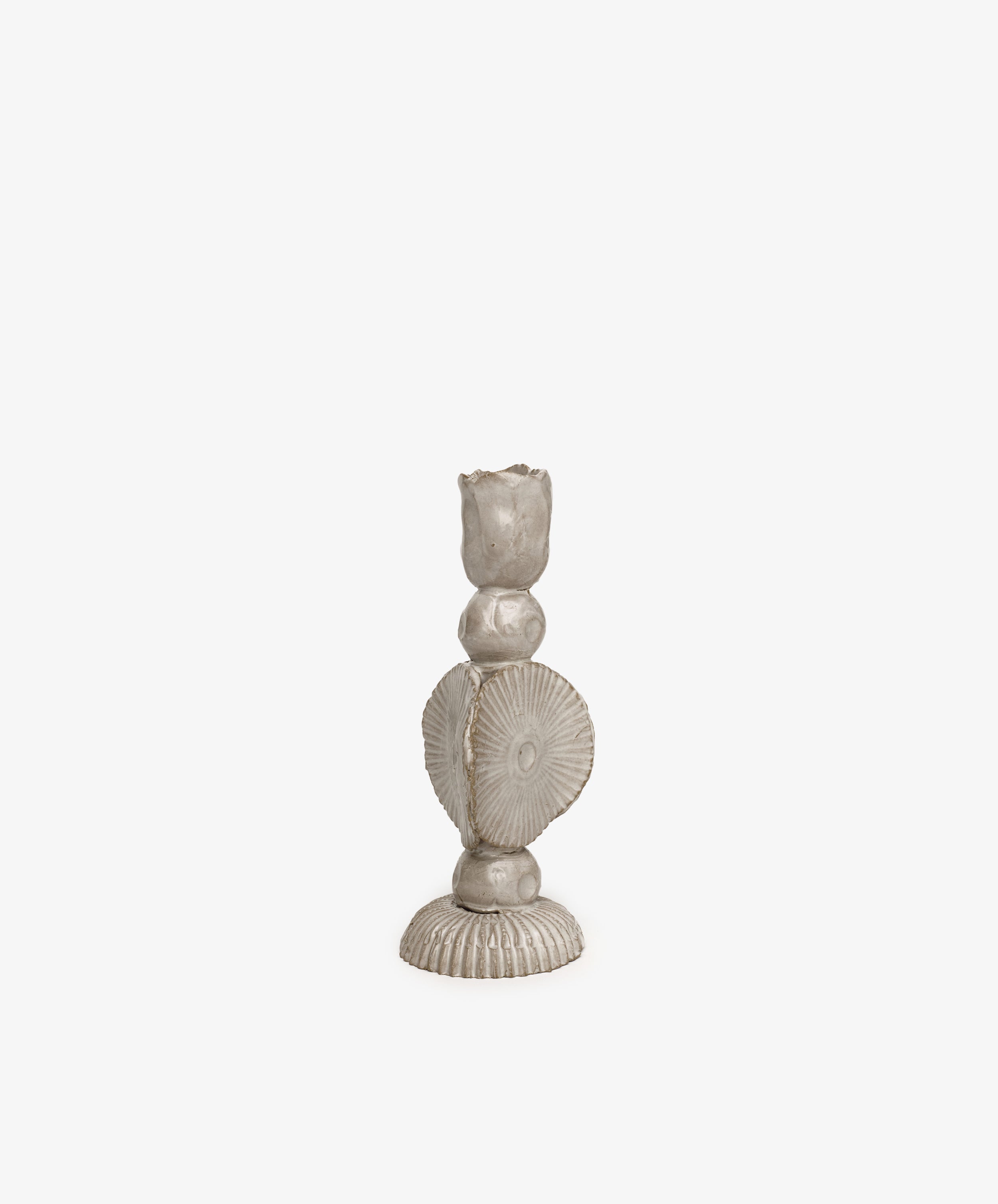 The Circulo Candleholder is a hand-moulded ceramic piece with a textured, sculptural form featuring circular and ridged elements, shown against a plain white background.