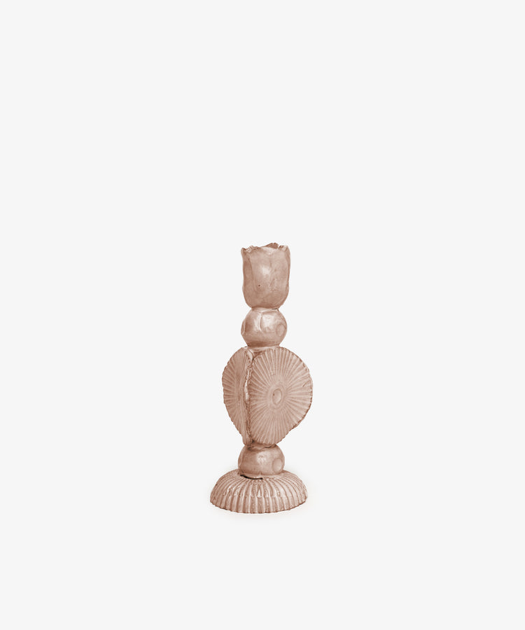 The Circulo Candleholder is a sculpted, light brown handmade piece with a textured decorative design of rounded and fan-shaped elements, shown against a plain white background.