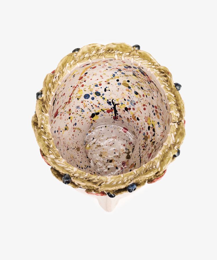 Overhead view of the Testa di Moro, Arandano ceramic cup featuring a textured golden rim and a speckled, multicolored interior—an artistic homeware piece that makes a sculptural statement.