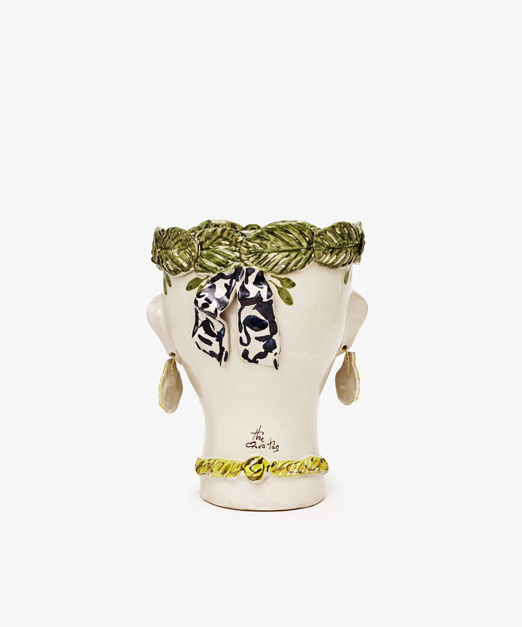 Testa di Moro, Alfonsina: a sculptural ceramic bust with a green braided headband, leaf earrings, green necklace, and black-and-white ribbon—perfect as unique homeware inspired by classic Testa di Moro heads.