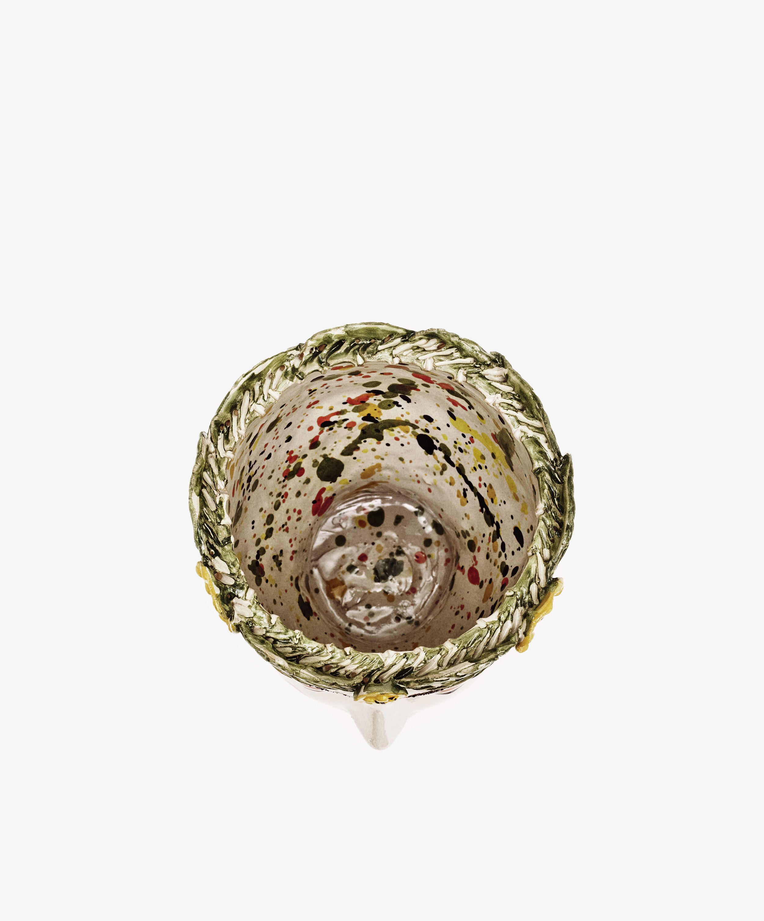 Top view of the Testa di Moro, Alfonsina—a small clear glass cup with colorful paint splatters and a decorative leafy green rim, ideal for adding sculptural flair to your homeware collection.