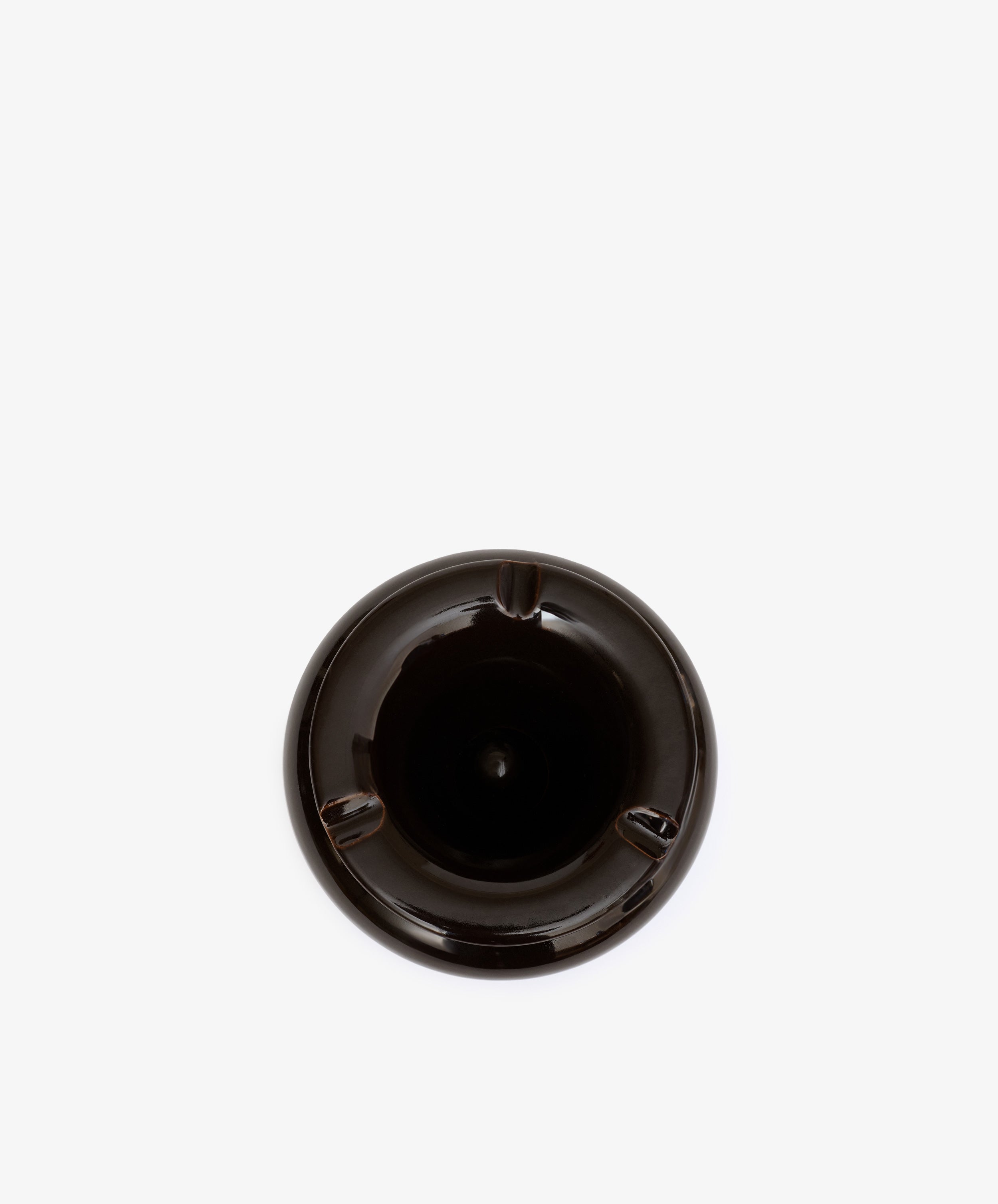 The Mix & Match Ashtray is a black, chunky ceramic piece with three grooves, shown from above on a plain white background. Expertly handmade in Italy.