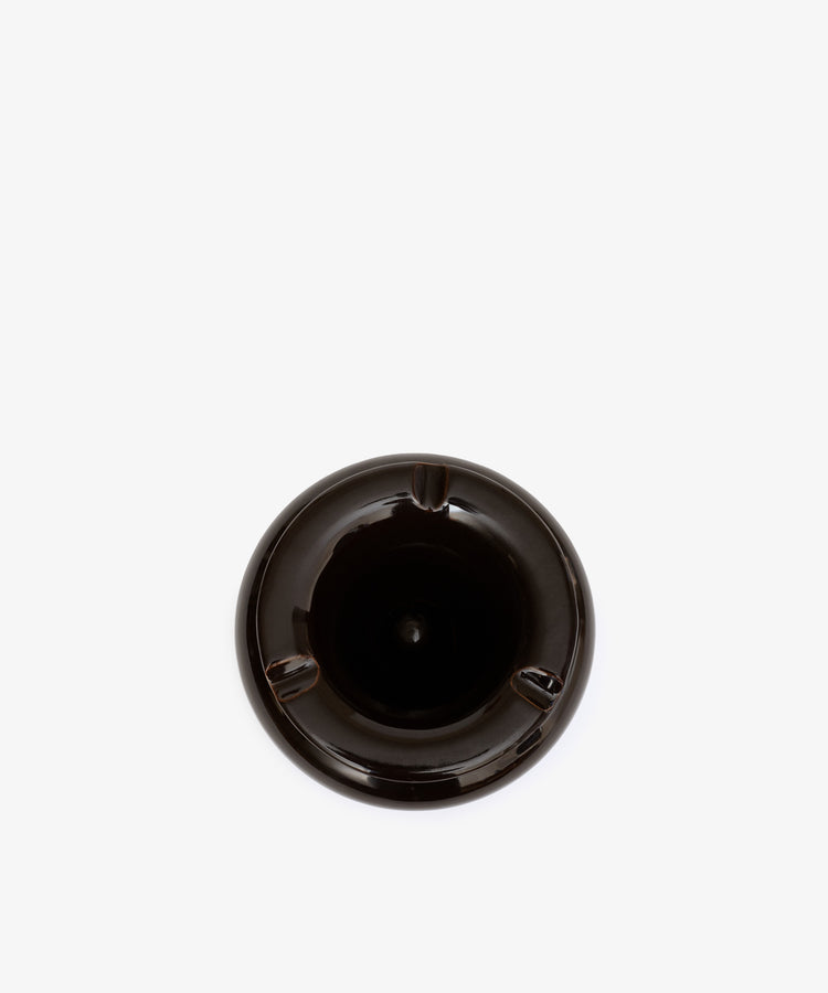 The Mix & Match Ashtray is a black, chunky ceramic piece with three grooves, shown from above on a plain white background. Expertly handmade in Italy.