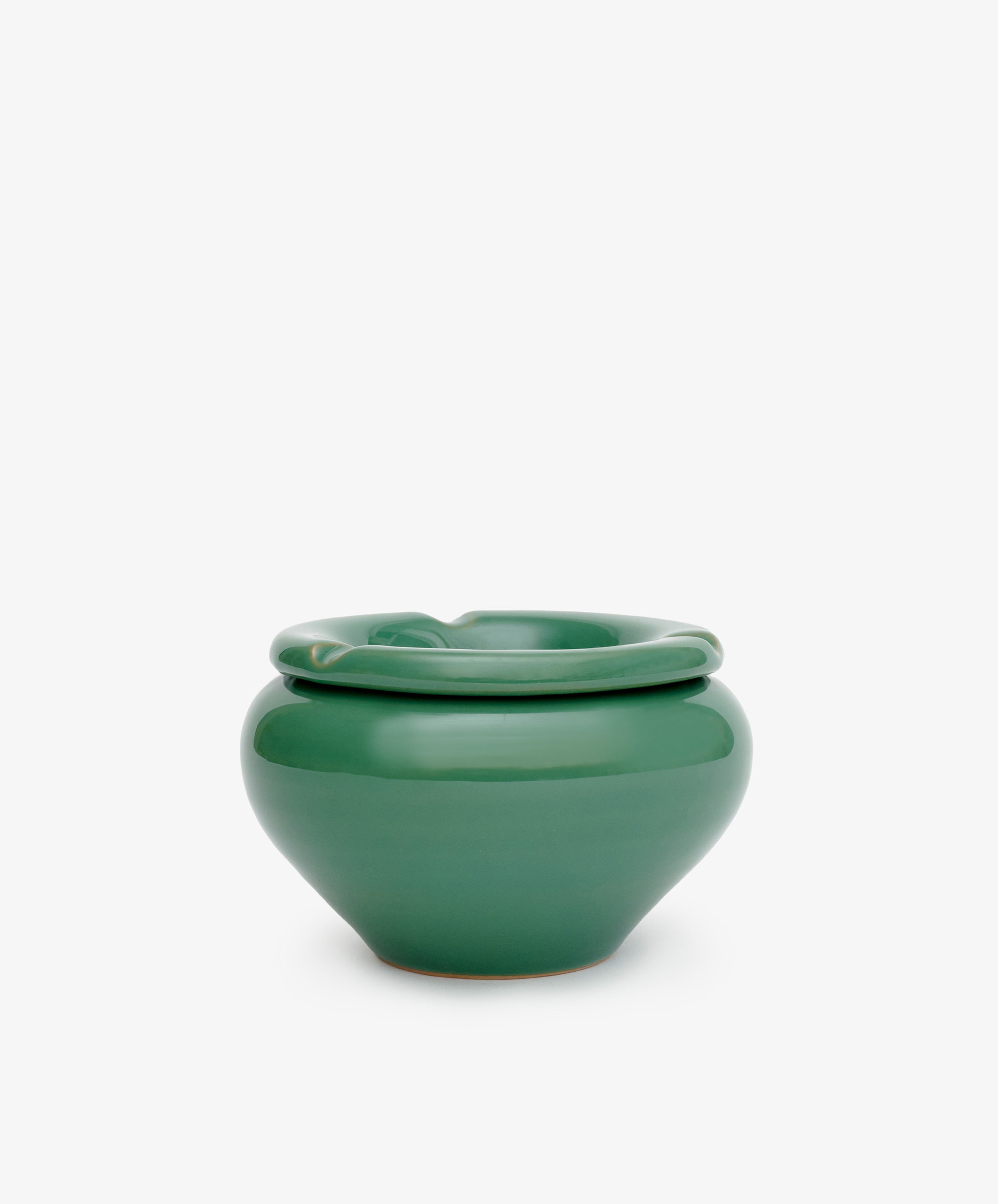 The Mix & Match Ashtray is a glossy green, hand-glazed ceramic pot with a wide rounded body and thick folded rim, exuding vintage charm against a plain white background.