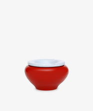 The Mix & Match Ashtray is a chunky, handmade ceramic piece from Italy, featuring a red, round shape with a white rim and displayed on a plain white background.
