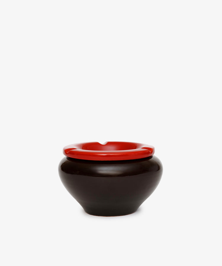 The Mix & Match Ashtray, a round black ceramic piece with a bold red rim, is displayed against a plain white background.