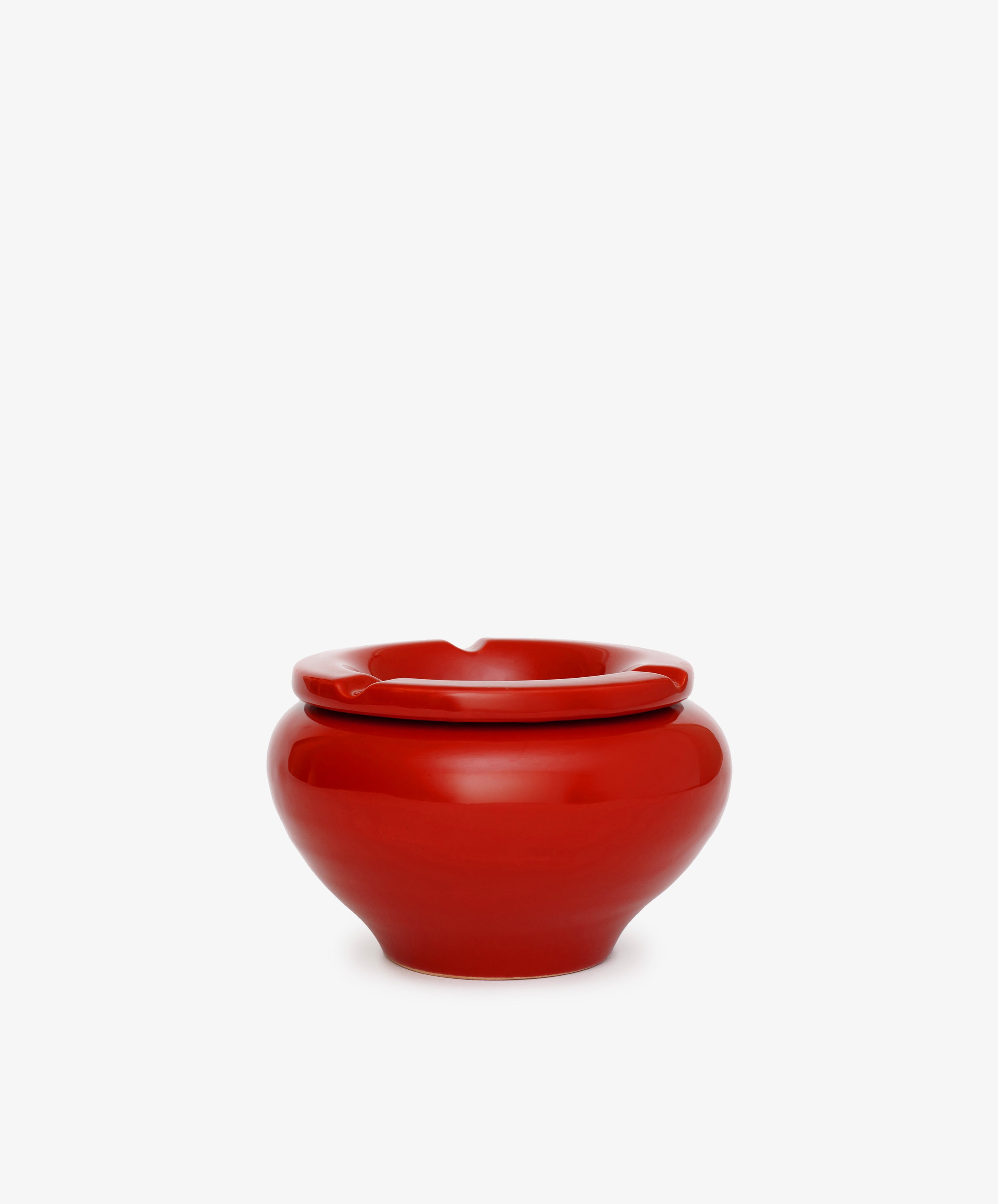 The Mix & Match Ashtray is a glossy, chunky ceramic piece with a rounded shape and a single rim notch, handmade in Italy and shown against a plain white background.