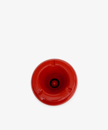 The Mix & Match Ashtray is a chunky, handmade ceramic piece from Italy, featuring a red circular design with three notches, shown from above on a plain white background.