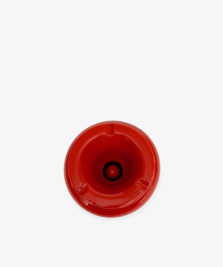 The Mix & Match Ashtray is a chunky, handmade ceramic piece from Italy, featuring a red circular design with three notches, shown from above on a plain white background.