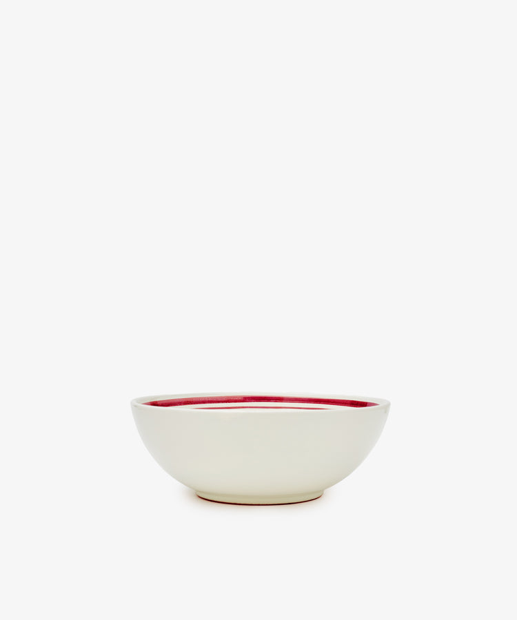 The Folk Cereal Bowl, Farmer features a white ceramic exterior and red interior, crafted by an Italian ceramist and shown against a plain white background.