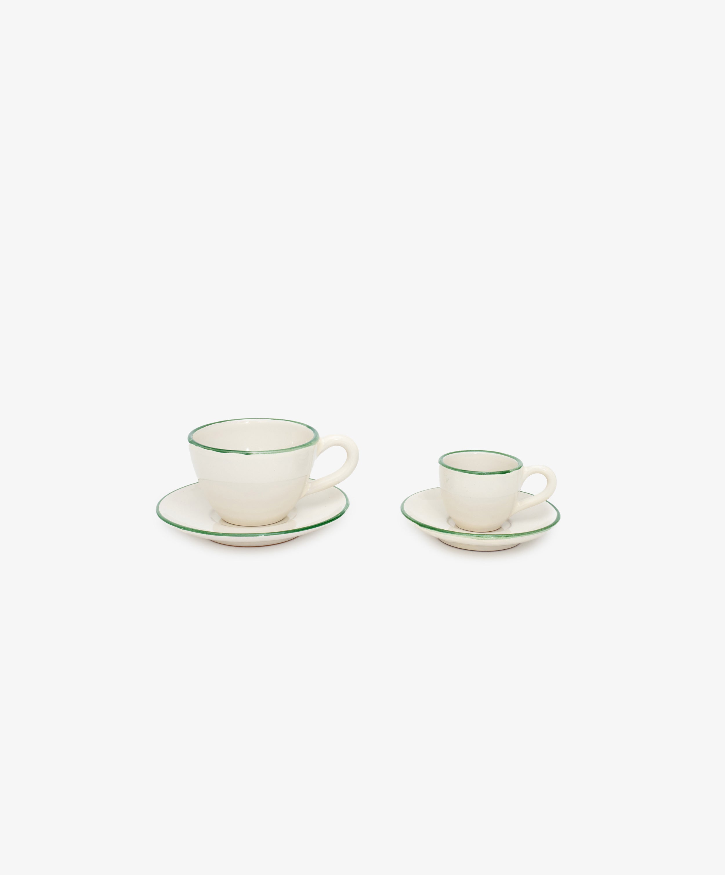 Two white glazed ceramic espresso cups with matching saucers and green painted stripe border. large and small.