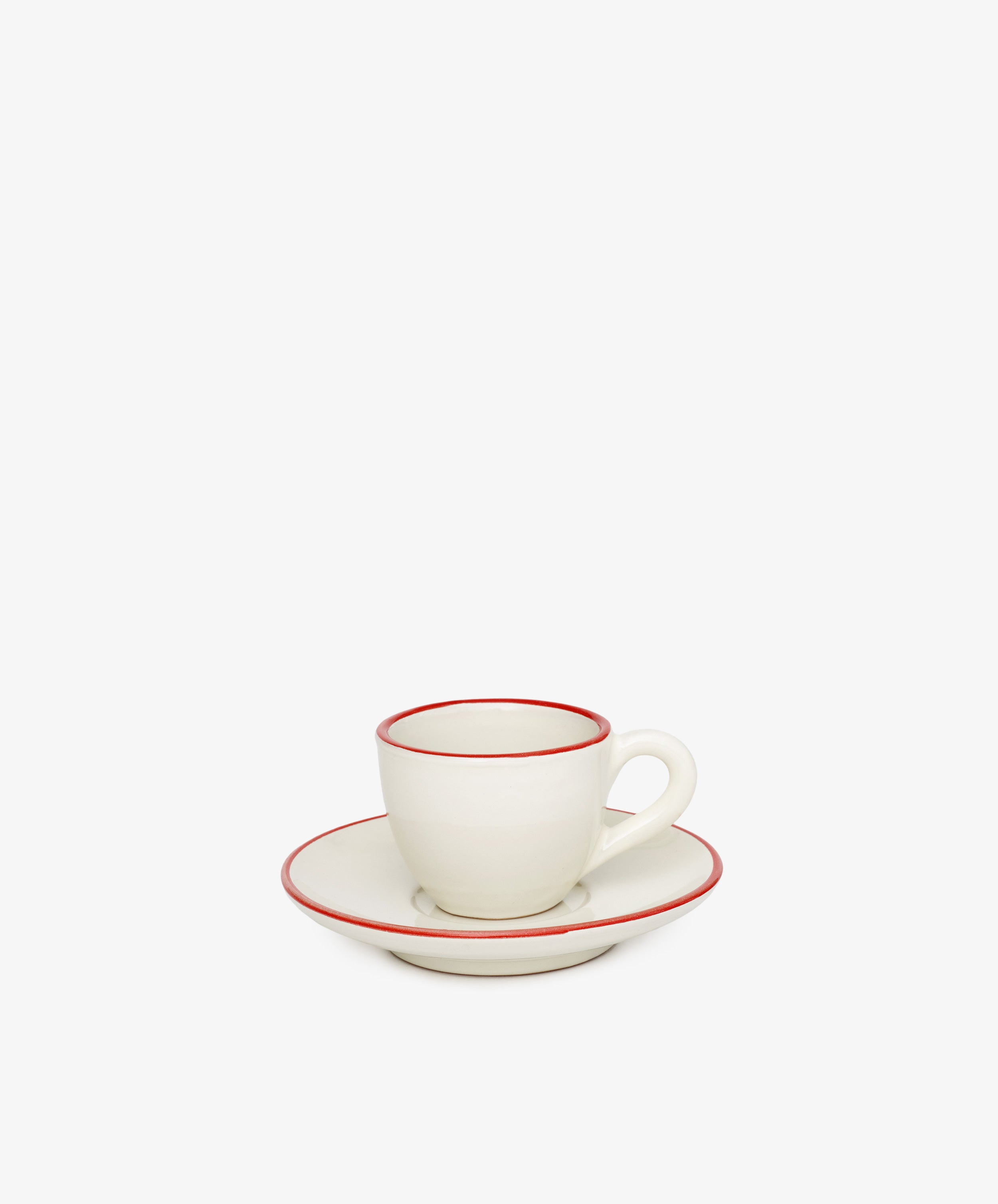 The Gio Espresso Set features a handmade ceramic espresso cup with a handle, resting on a matching saucer and plate—each edged with a slim red line—displayed against a plain white background.